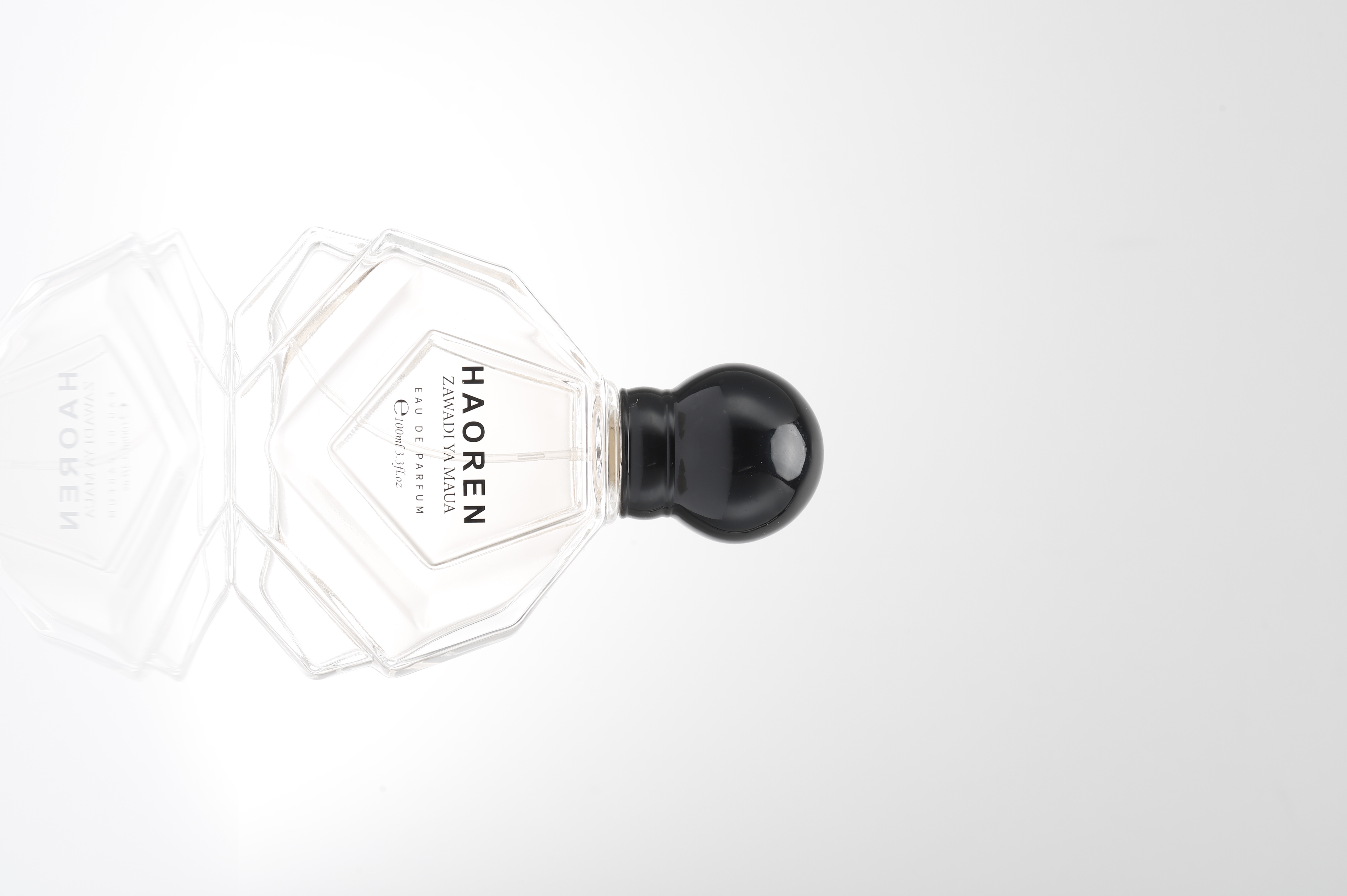 Hand holding perfume bottle